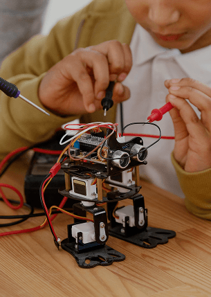 Student assembling a robot