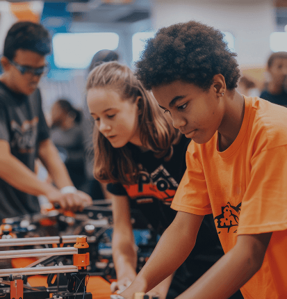 Students building robotics projects together